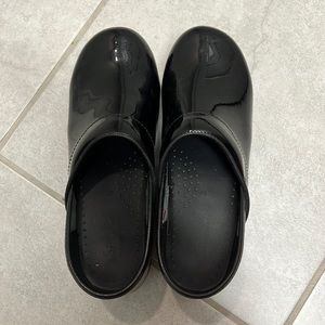 Sanita black patent clogs